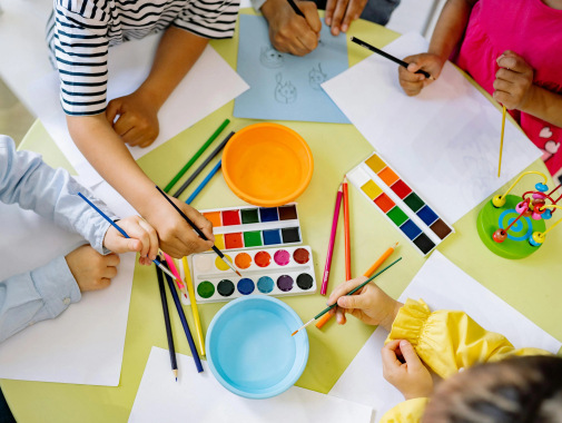 Children painting and drawing together